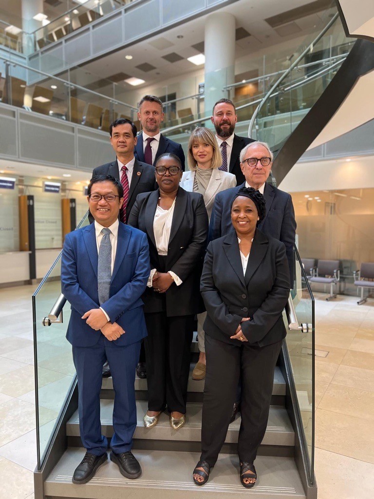 Judges from the 2023 Observation Programme sat around a conference table with leading professionals and experts
